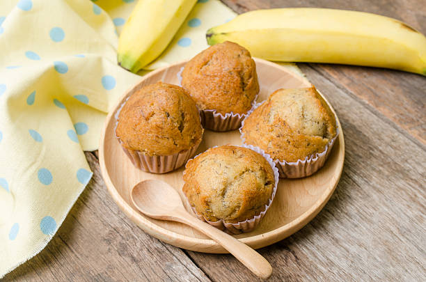 istock Banana muffins cupcake on wooden background 626248892