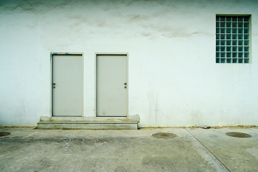Two doors on a white wall background