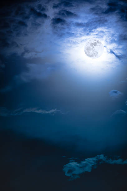 istock Nighttime sky with clouds and bright full moon with shiny. 626257074
