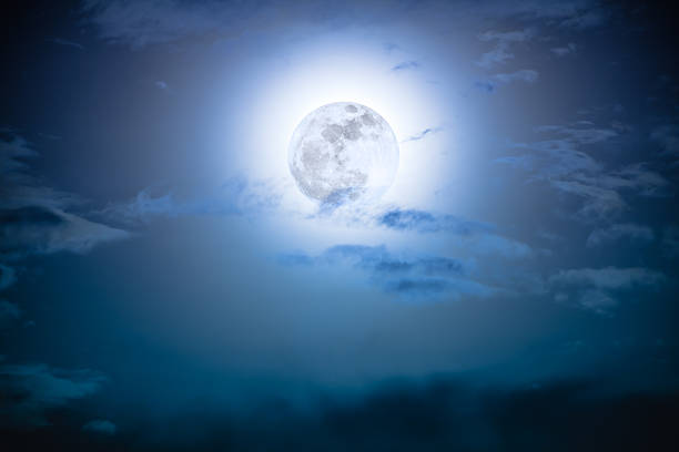 istock Nighttime sky with clouds and bright full moon with shiny. 626257390