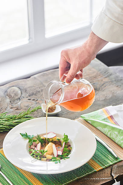 istock Hand pouring home-made kvass in okroshka 626257920