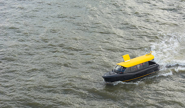 Water Cab crossing the River Visitors of Rotterdam can take  a water cab as their form of transportation watertaxi stock pictures, royalty-free photos & images