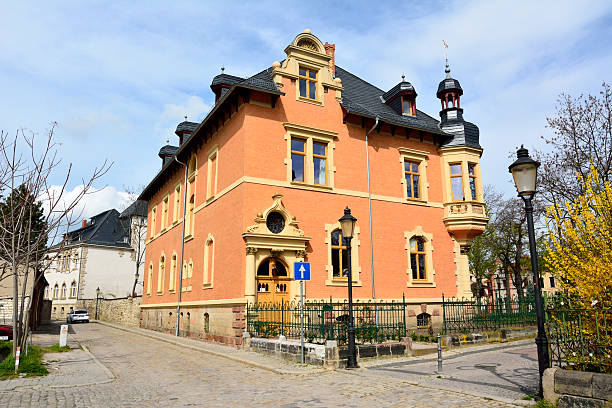 Naumburg, Germany  - April 13, 2016. Historic building on Marienmauer street in Naumburg, with vegetation.