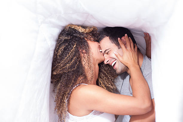 latin couple under the sheets - funnyface imagens e fotografias de stock