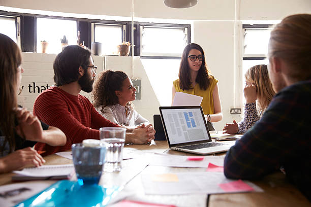 istock Female Manager Leads Meeting Around Table In Design Office 626261108
