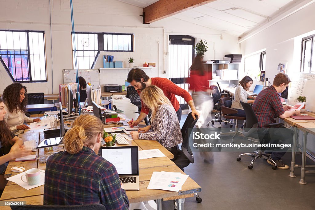 Interior Of Busy Design Office With Staff Office Stock Photo