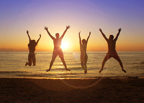 istock Group of happy young people jumping on the beach 626263214