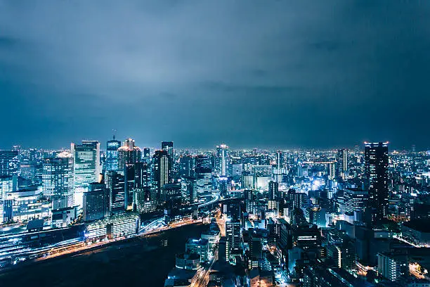 Osaka cityscape by night. Panoramic view from skyscraper.  