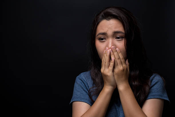 istock Sad woman on isolated black background 626263866