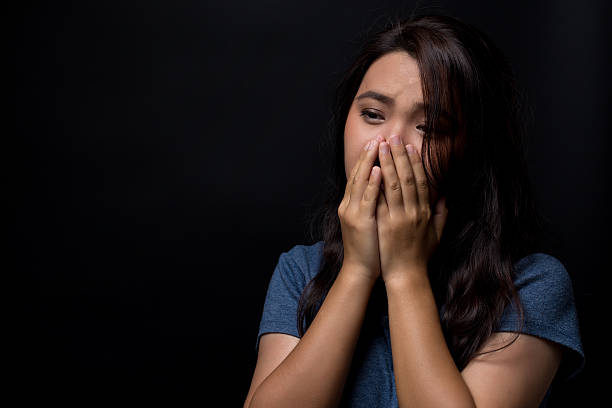 istock Sad woman on isolated black background 626264084