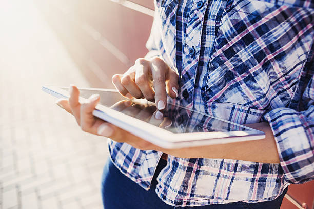 Girl using digital tablet outdoors