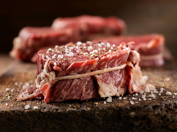 raw bacon wrapped steak fillets seasoned with salt and pepper - meat beef raw freshness imagens e fotografias de stock