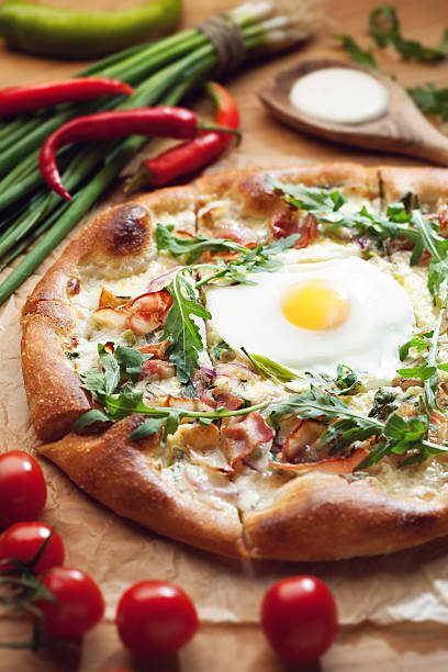 istock Fresh pizza with ingredients on wooden table 626265398