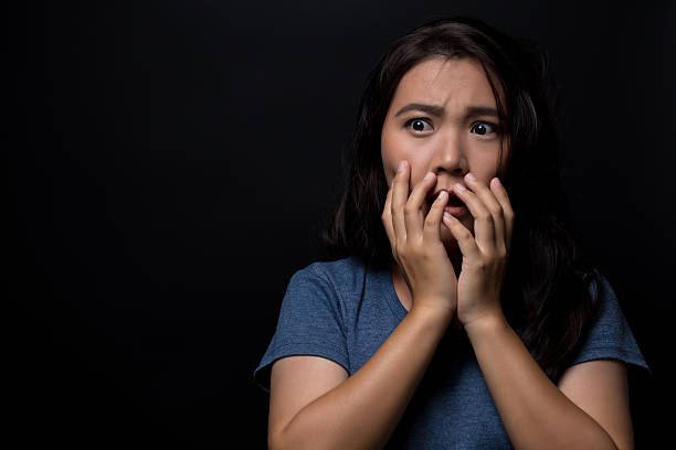 istock Shocked woman on isolated black background 626269076