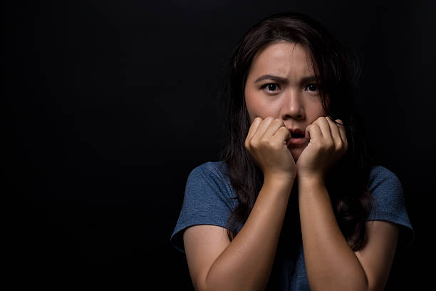 istock Shocked woman on isolated black background 626269406