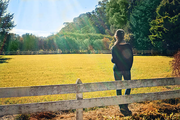 istock girl looking at the field 626270068