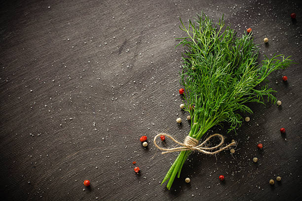 istock bunch of fresh dill on dark wood background 626270600