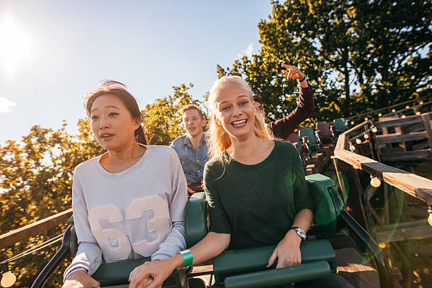 istock Happy young people riding a roller coaster 626271488