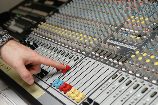 Photography of a sound engineer works with sound mixer