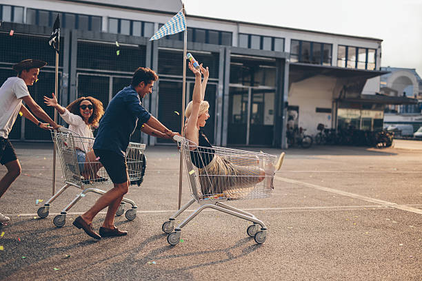 istock Young friends racing with shopping carts 626291230