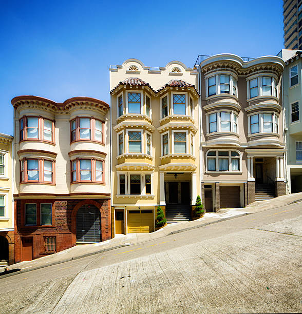 Row of San Francisco townhouses built on steep hill Row of colorful Italian style San Francisco townhouses built on steep hill. san francisco california street stock pictures, royalty-free photos & images