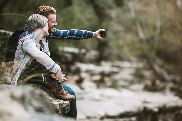 Modern Couple Taking Selfie By River