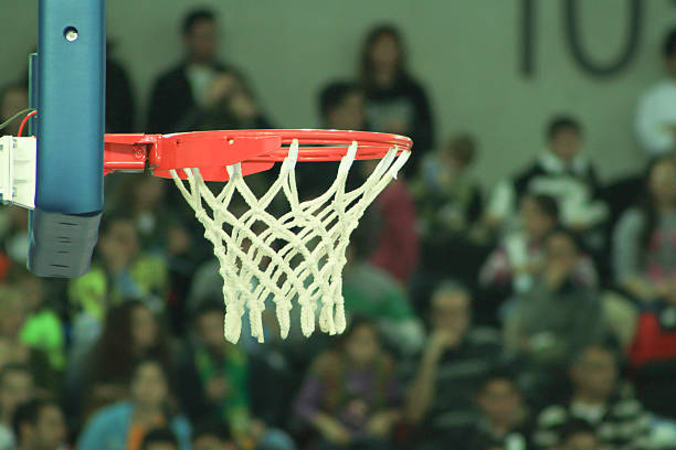 istock basketball while enters in the basket during basketball game 626303838