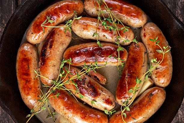istock Home-made Pork Sausages in rustic pan with thyme 626303890