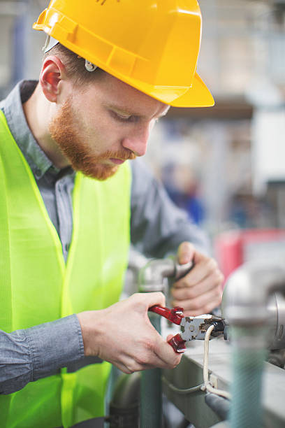 istock Young man fixing a machine in factory 626304762