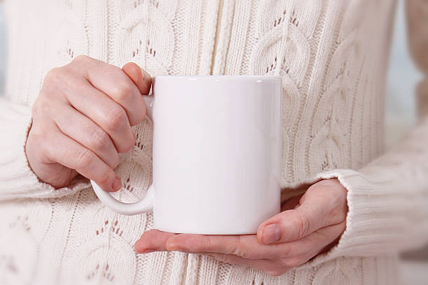 istock Girl in warm sweater holds white mug, Mockup 626310770