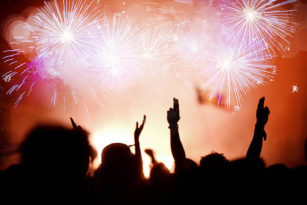 istock Crowd celebrating the New Year with fireworks 626321476
