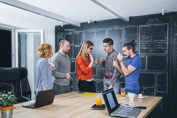 Casual business people working together with computer in office