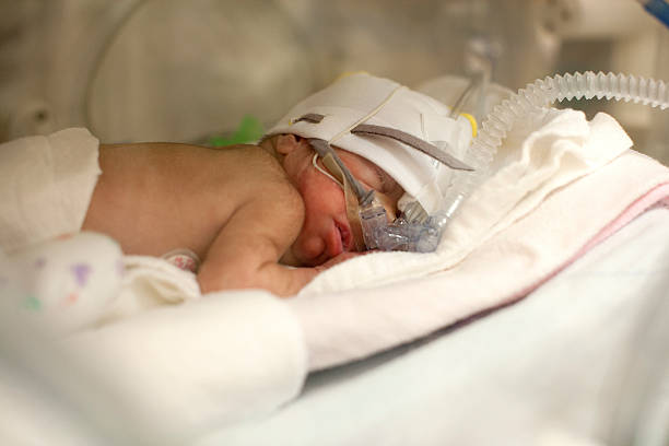 Preemie Premature infant in incubator in Intensive Care Unit. medical oxygen equipment stock pictures, royalty-free photos & images