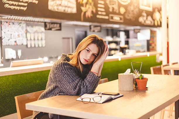 istock Young woman freelancer sitting in cafe after hard work day. 626322688