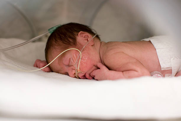 Premature baby sleeping stock photo