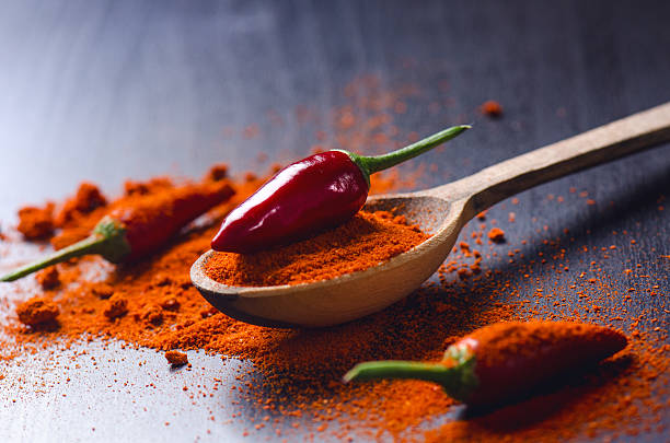 istock Red chilly peppers on a wooden, black table with spicy. 626324468