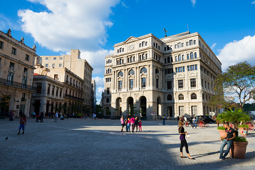 Havana, Cuba - December 13, 2014: People enjoy a sunny day in Plaza de San Francisco in Havana, Cuba. The plaza faces the Convento de San Francisco de Asís (not pictured), formerly a church and monastery but now a museum and concert hall.