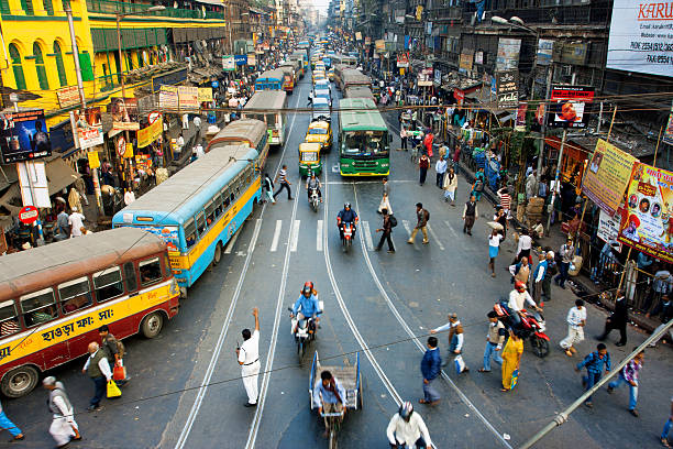 pedestrians cross road in front of motorcycles, cars in india - india car people business imagens e fotografias de stock