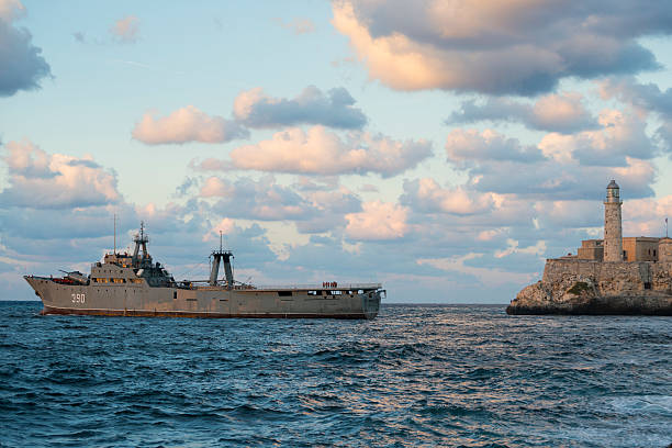 Cuban navy Rio Damuji class warship leaving Havana Harbor Havana, Cuba - December 13, 2014: Cuban sailors stand on deck as their ship, a Rio Damuji class frigate, sails out of Havana Harbor. The largest warship in the Cuban Navy, it was built from old Spanish fishing trawlers. havana harbor photos stock pictures, royalty-free photos & images