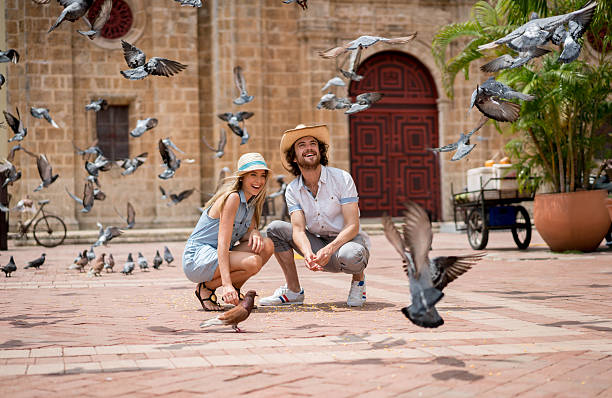 Tourists feeding doves in Cartagena