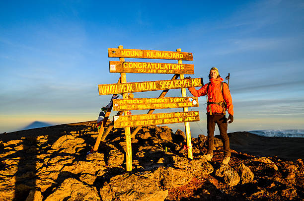 Hiker at Uhuru Peak, Kilimanjaro - Tanzania, Africa stock photo