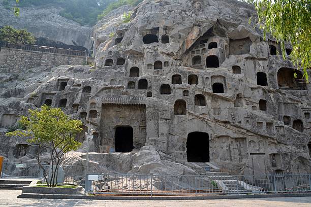 The Unesco world heritage site of Longmen Grottoes, Luoyang, Henan province. The Caves are one of the finest examples of Chinese Buddhist art. Housing tens of thousands of memes of Buddha and his disciples, The images, were carved as outside rock reliefs and inside artificial caves excavated from the limestone cliffs of the Xiangshan and Longmenshan mountains - China 