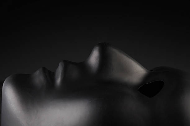 istock Black anonymous face mask laying looking up on black background. 626350042