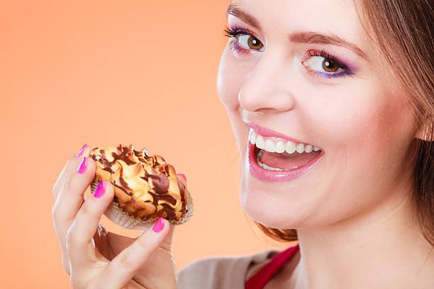 istock Smiling woman holds cake in hand 626350840