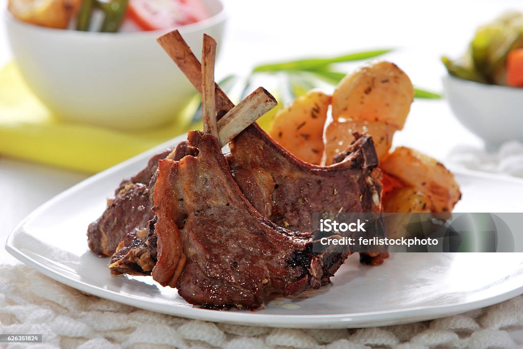 Grilled lamb chops portrait of grilled lamb chops served with grilled potatoes and mix vegetables Lamb Chop Stock Photo