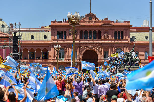Argentine people wave flags in front of the government house stock photo