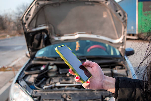 istock Girl near a broken car is calling for help 626353832