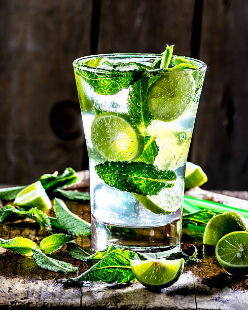 istock Mojito cocktail with lime and mint on wooden rustic background 626361334