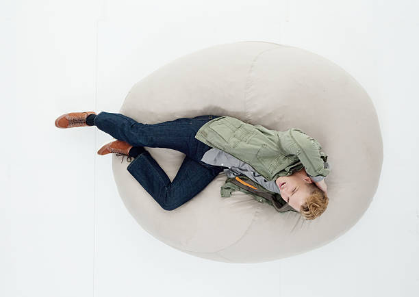 istock Above view of man lying on bean bag 626370372