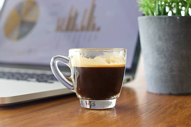 istock Laptop and coffee cup on old wooden table 626371104